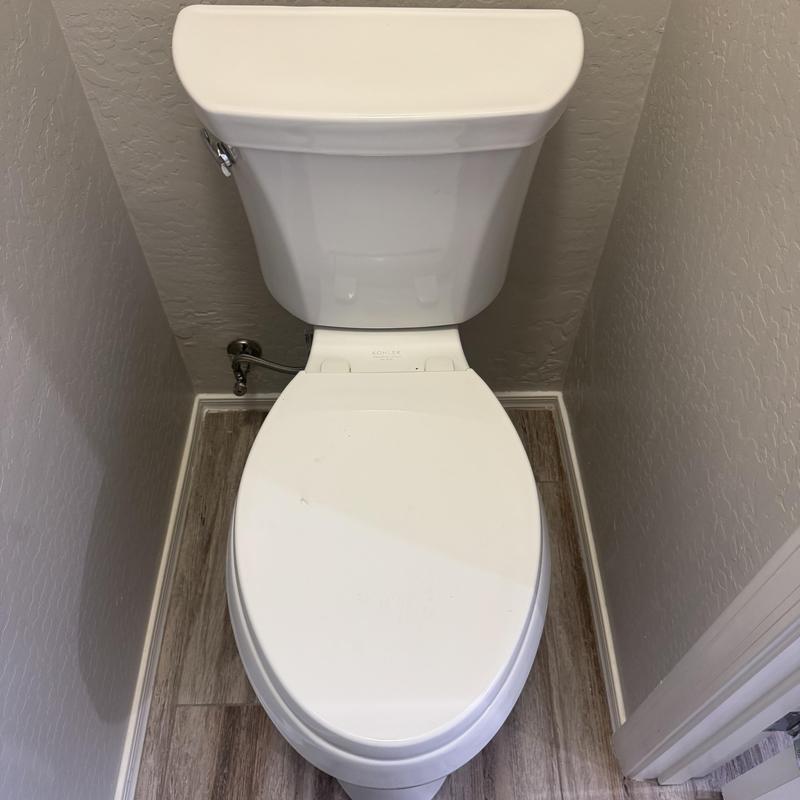 Toilet with repaired flange reinstalled in bathroom
