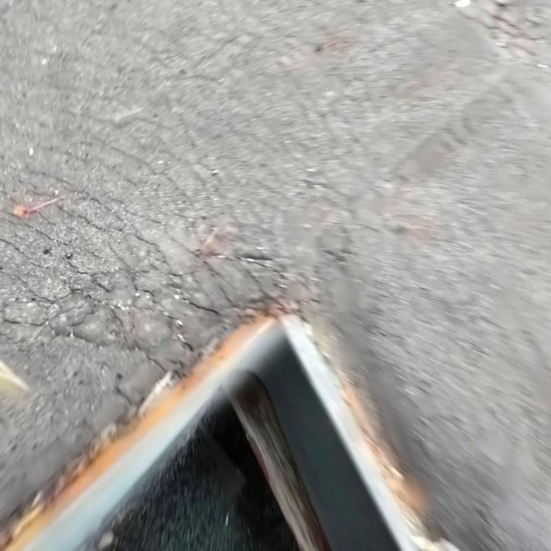 Flat roof with cracked seams near metal flashing edge Flat roof with cracked seams near metal flashing edge