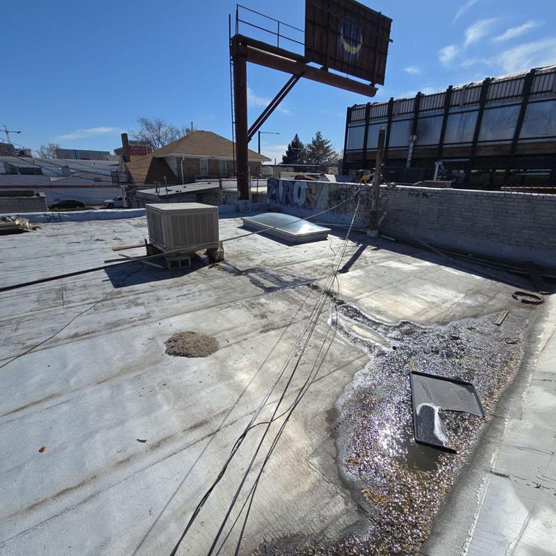Flat roof with ponded water and HVAC unit Flat roof with ponded water and HVAC unit