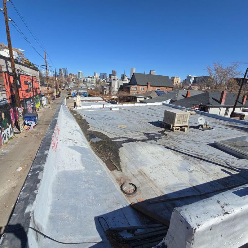 Flat roof with temporary patch repairs and HVAC unit Flat roof with temporary patch repairs and HVAC unit