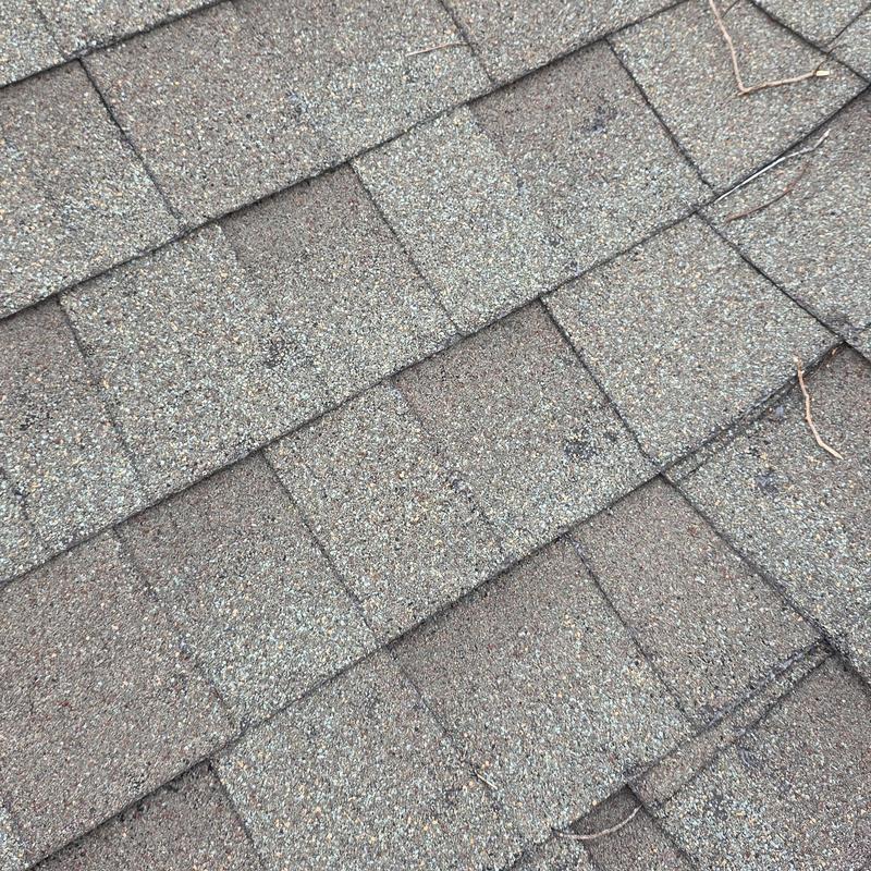Asphalt shingles with minor surface wear and granule loss