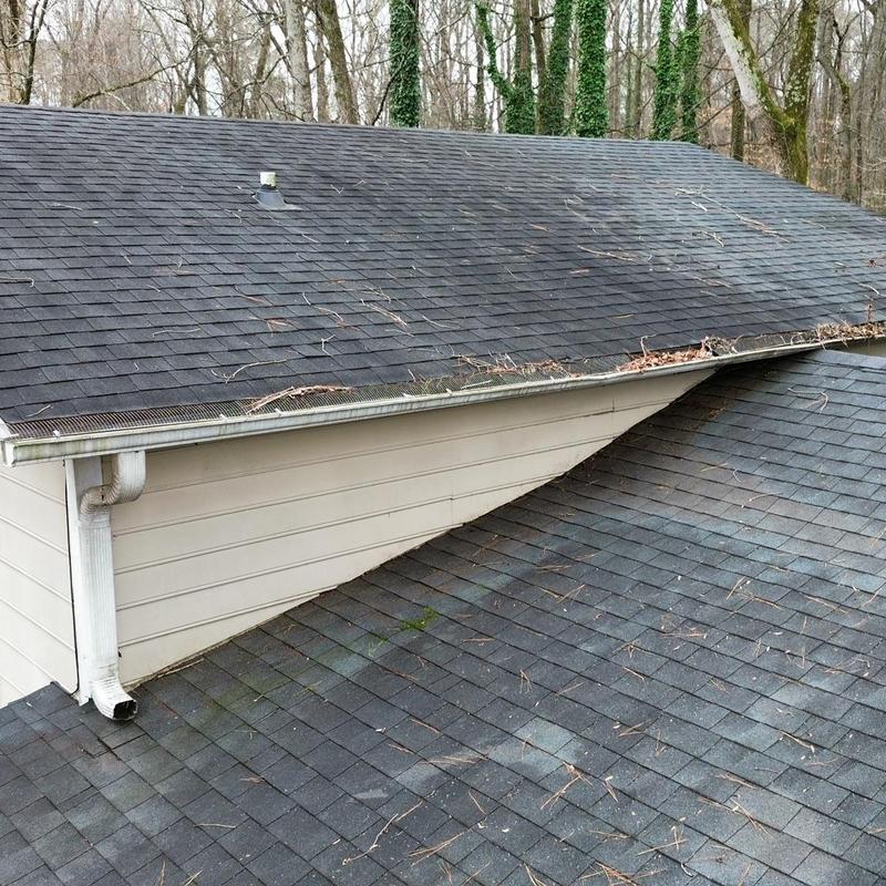 Roof shingles with debris and slight wear on slopes