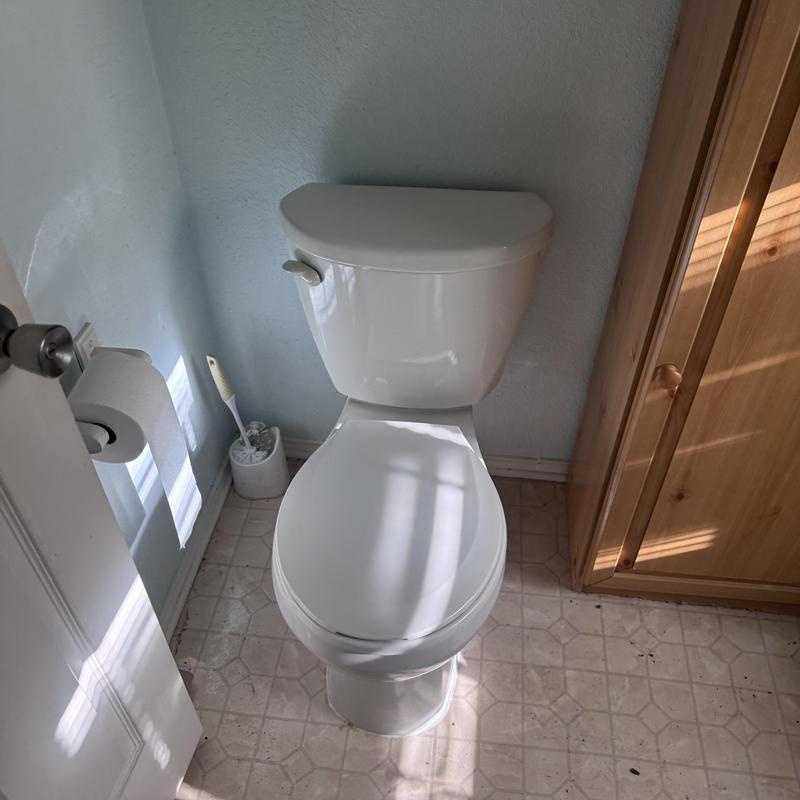 Toilet replacement with caulked base in bathroom