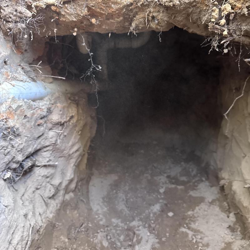 Sewer pipe tunnel excavation for repair in soil trench