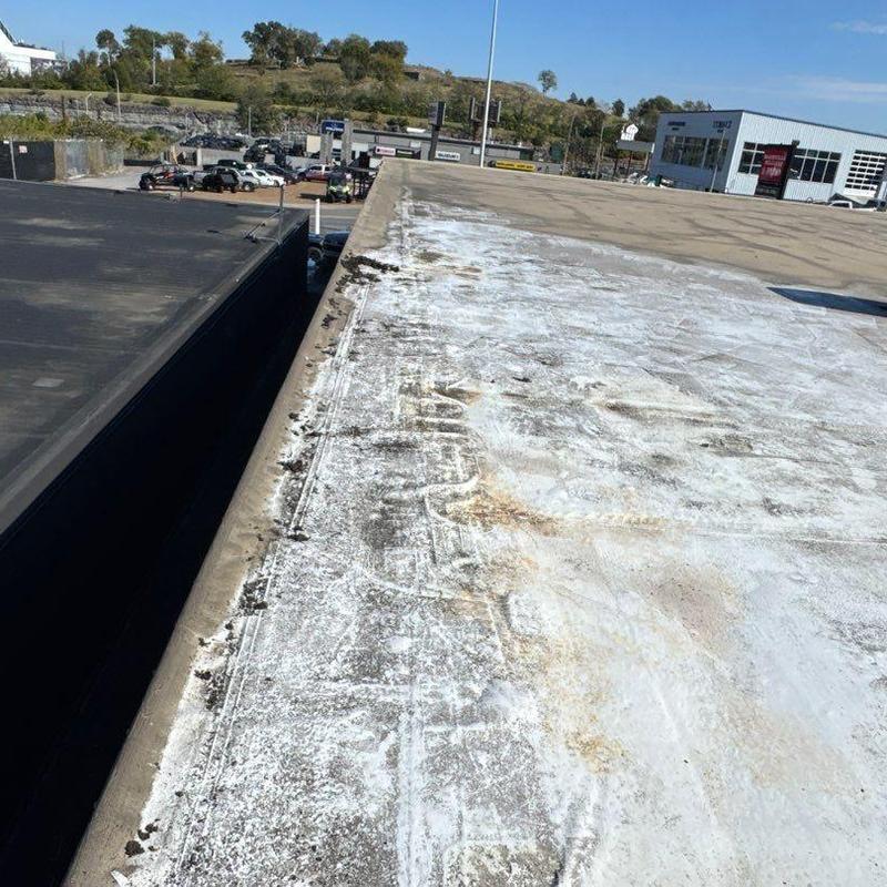 TPO commercial flat roof with weathering and debris