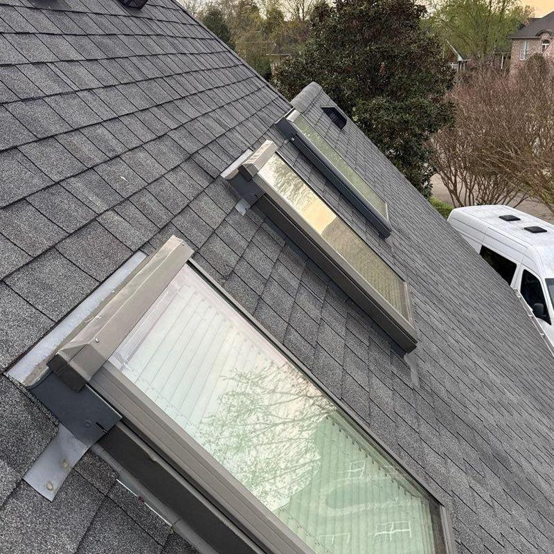 Asphalt shingle roof with skylight flashing seals inspection