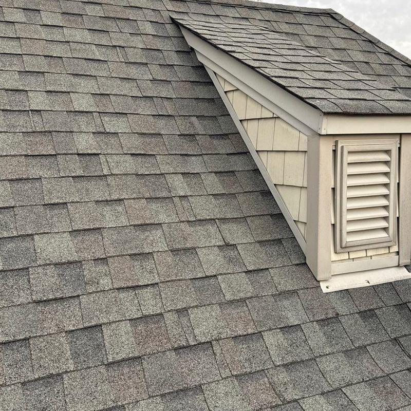 Asphalt shingle roof with dormer and ventilation vent