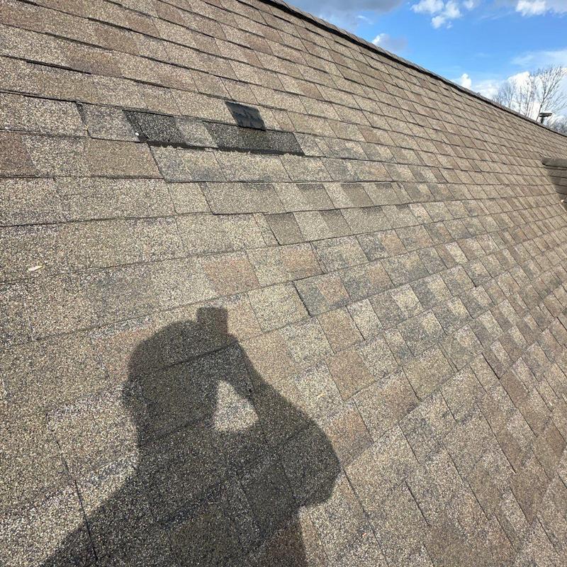 Asphalt shingle roof with hail damage and inspected ridge