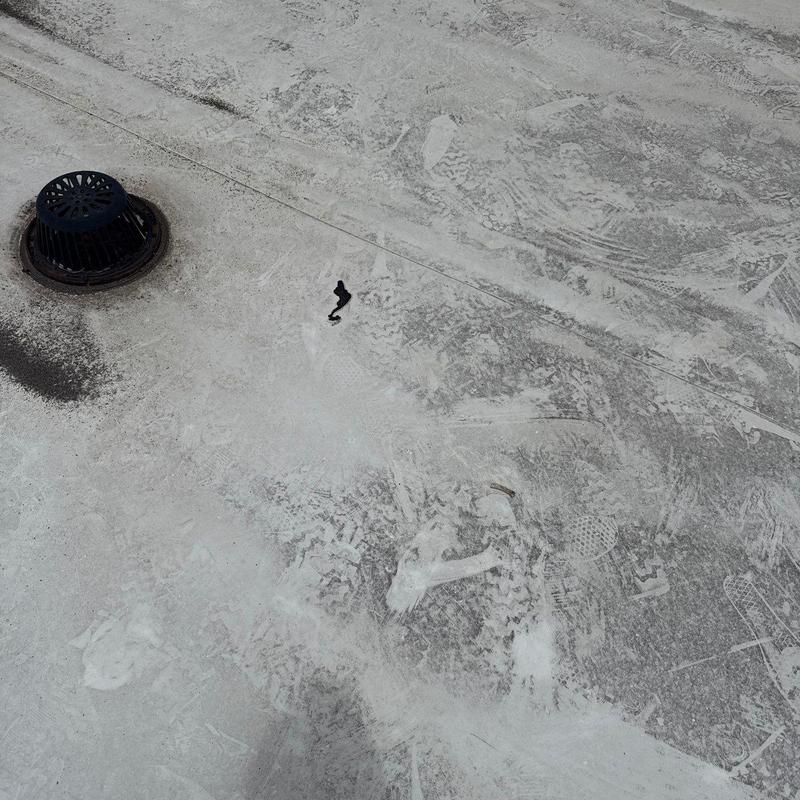 TPO commercial roof with drain and surface debris