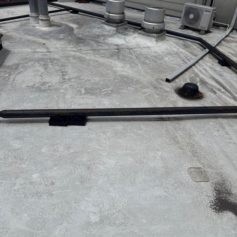 TPO roofing system with ventilation pipes and drain