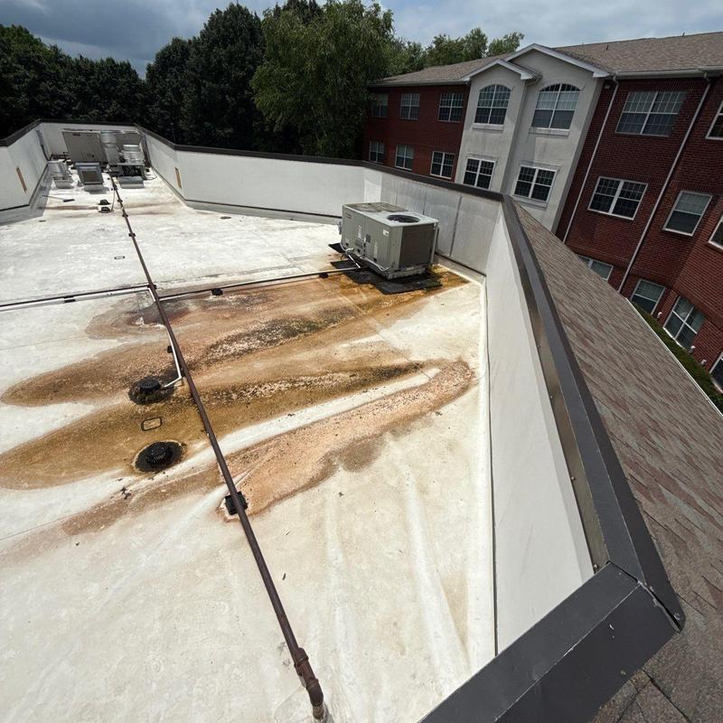 TPO roofing with rust stains near rooftop HVAC unit