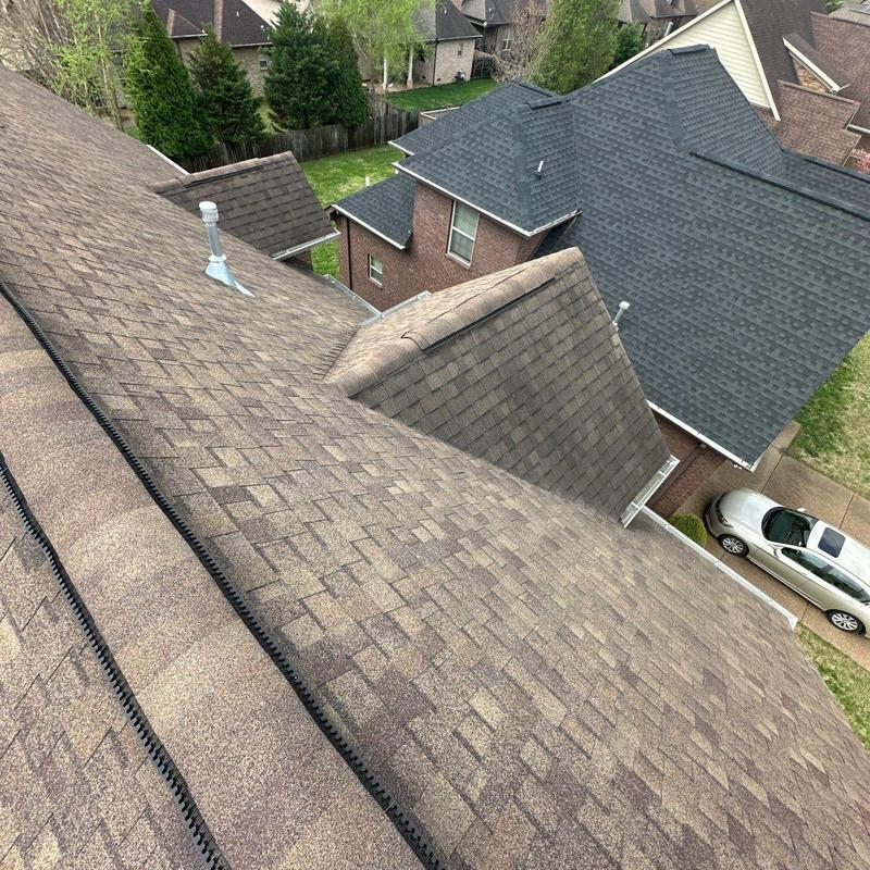 Asphalt shingle roof with ridge vent and flashing inspection