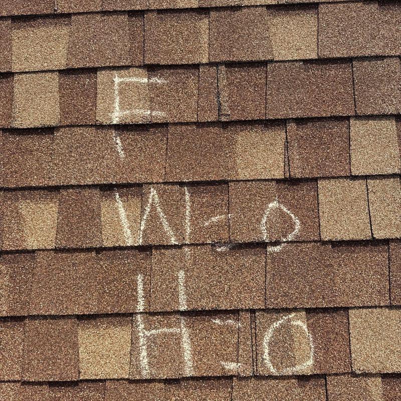 Roof shingles with chalk markings for inspection