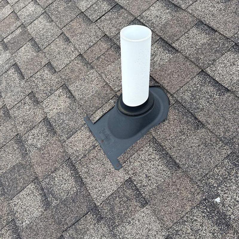 Roof pipe flashing on shingle roof with hail damage