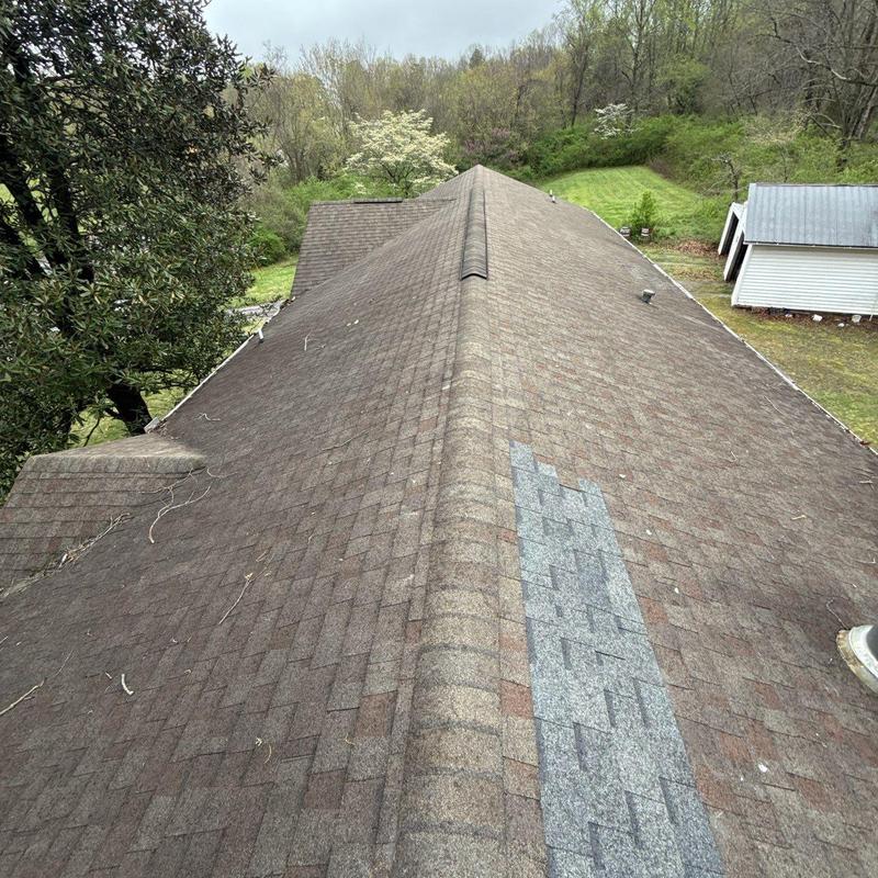 Asphalt shingle roof with partial replacement patch