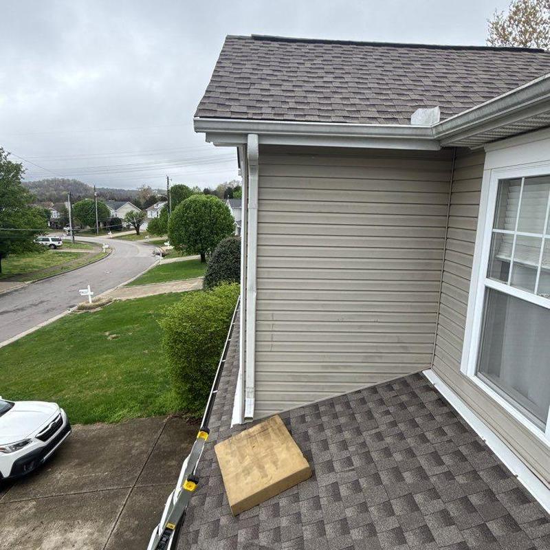Asphalt shingle roof with gutter and ventilation pipe