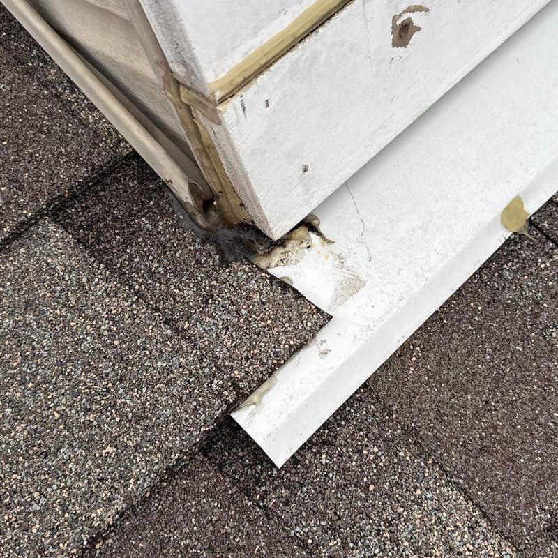 Roof flashing corner with damage and debris buildup