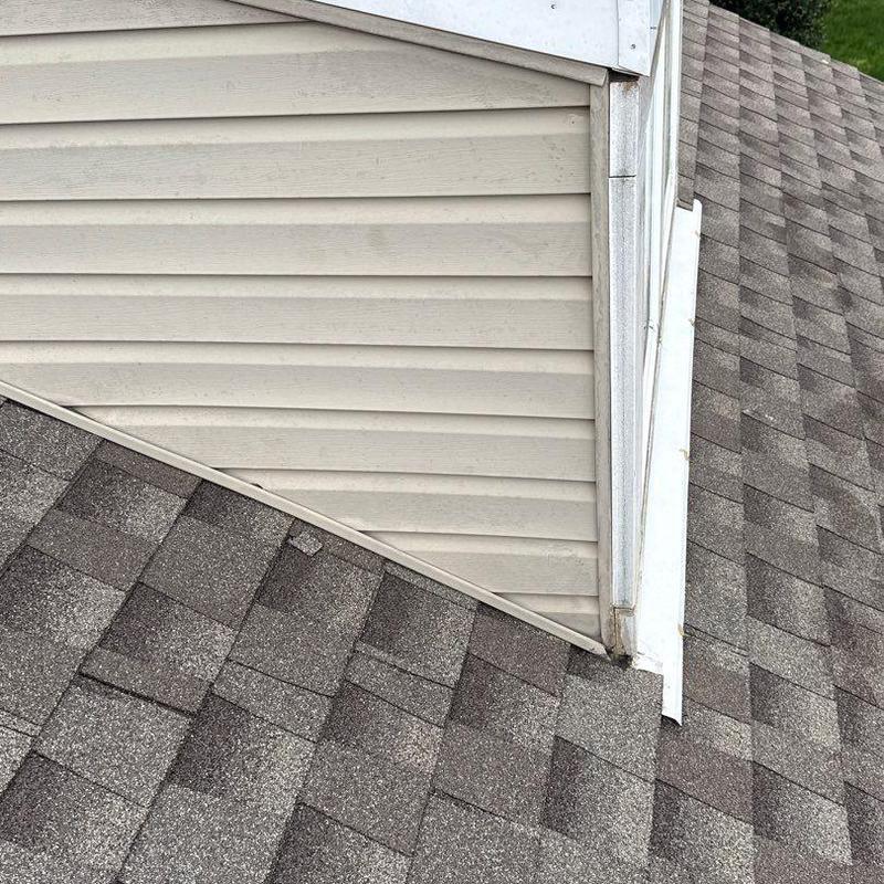 Roof shingles and flashing at siding transition
