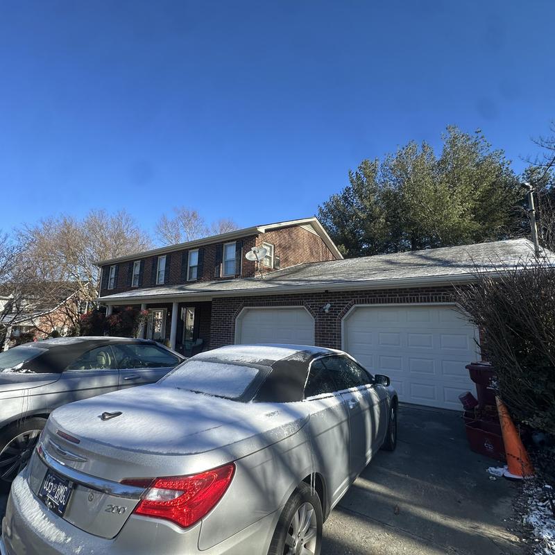 Metal roof on residential home with light snow cover