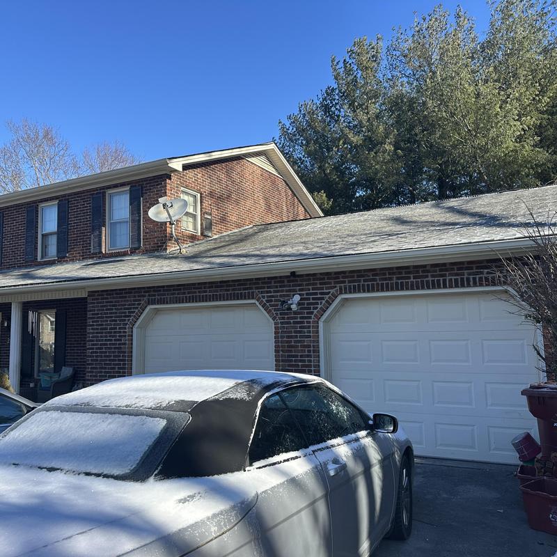 Satellite dish installation on brick residential home roof