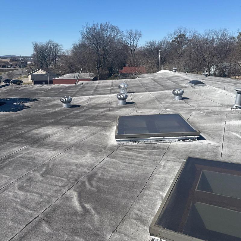 Modified bitumen flat roof with vents and skylights