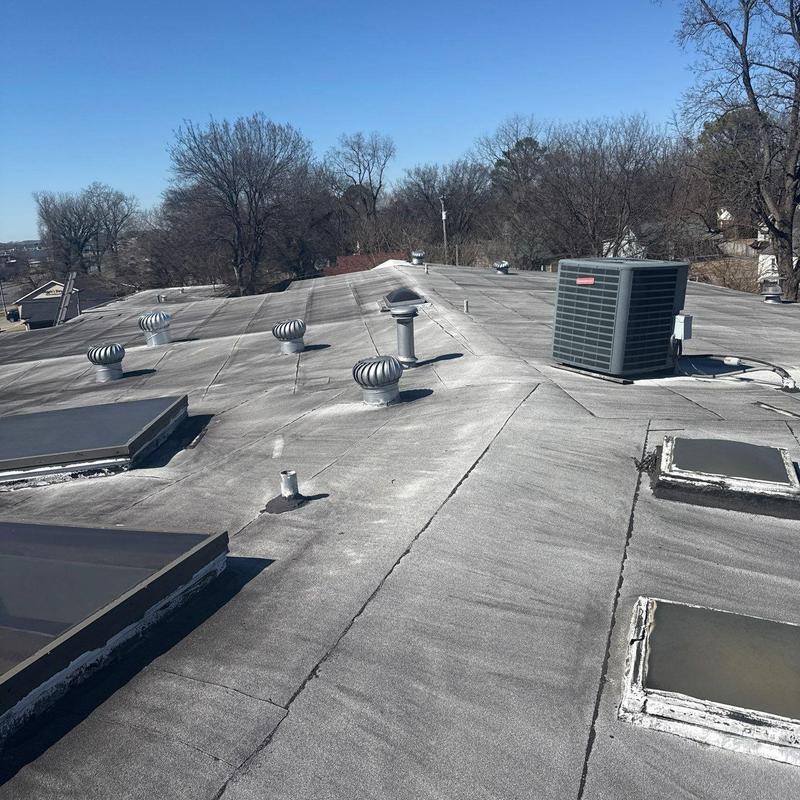 Modified bitumen flat roof with vents and HVAC unit
