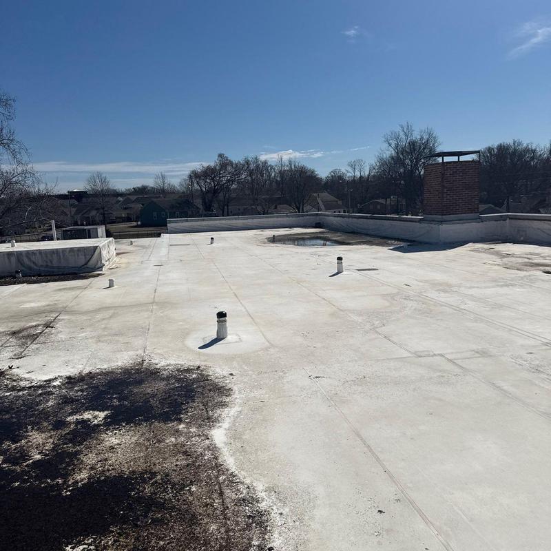 PVC membrane flat roof with vents and chimney