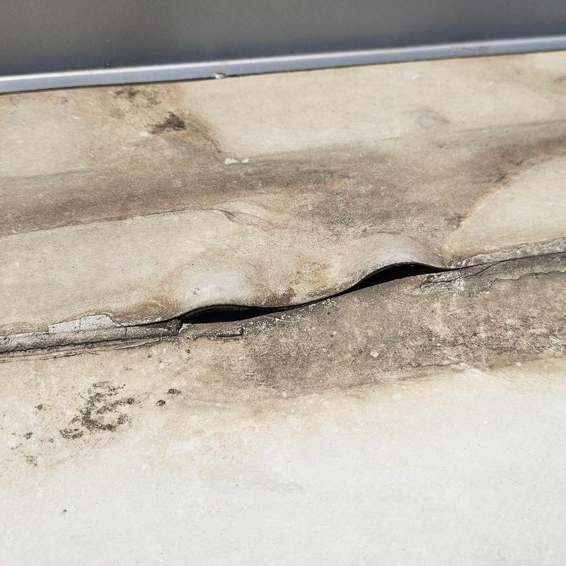 TPO roofing membrane with split seam damage TPO roofing membrane with split seam damage