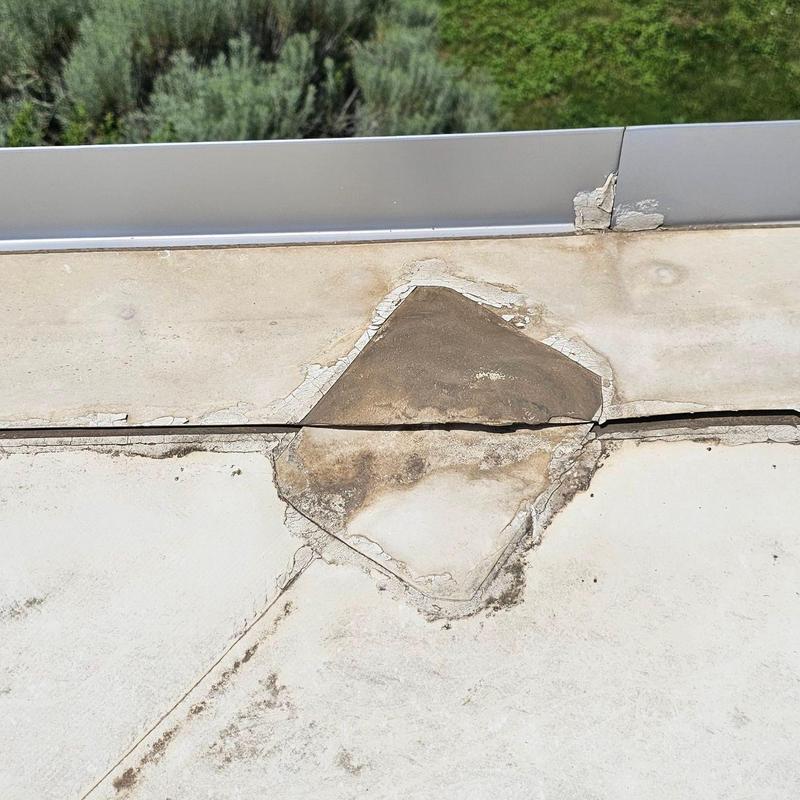 TPO flat roof with cracked and damaged seams TPO flat roof with cracked and damaged seams