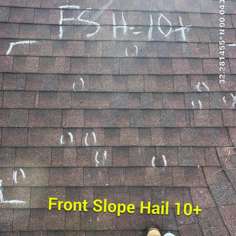Asphalt shingle roof with hail damage markings Asphalt shingle roof with hail damage markings