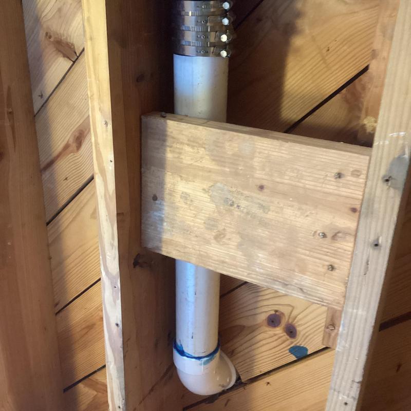 PVC flange plumbing repair inside wooden framing
