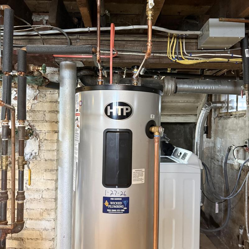 Water heater installation with copper piping in basement