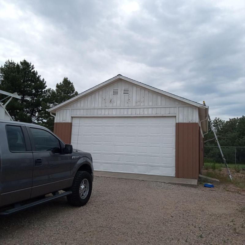 Garage roof with hail damage and inspection ladder Garage roof with hail damage and inspection ladder