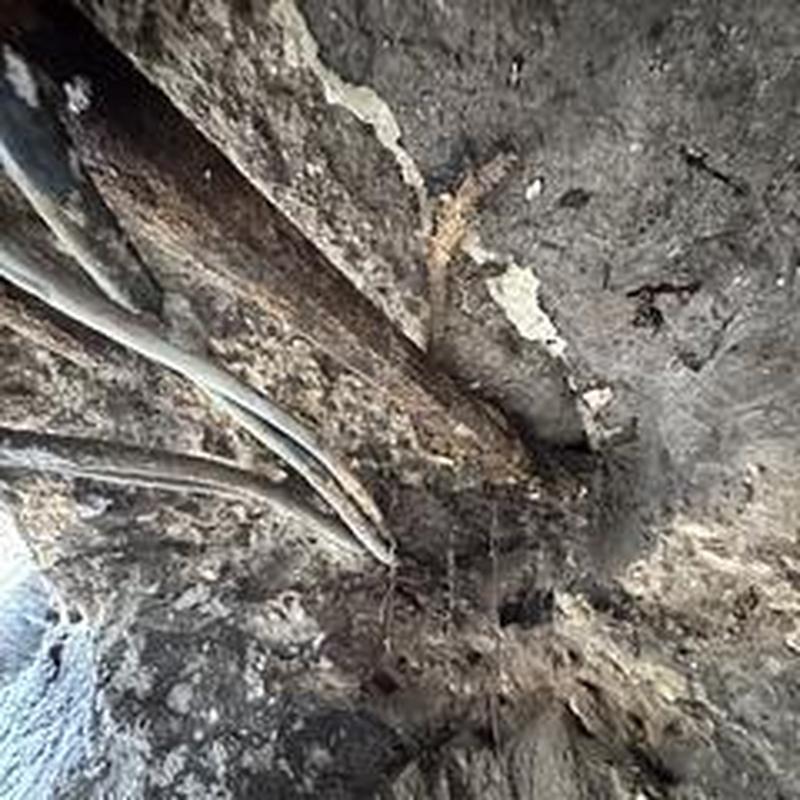 Drain system tunneling under concrete slab with rods