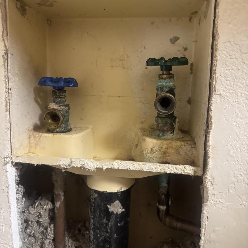 Laundry water valves with corrosion in wall niche