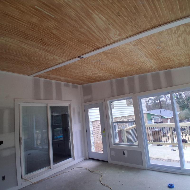 Patio enclosure framing and window installation in progress