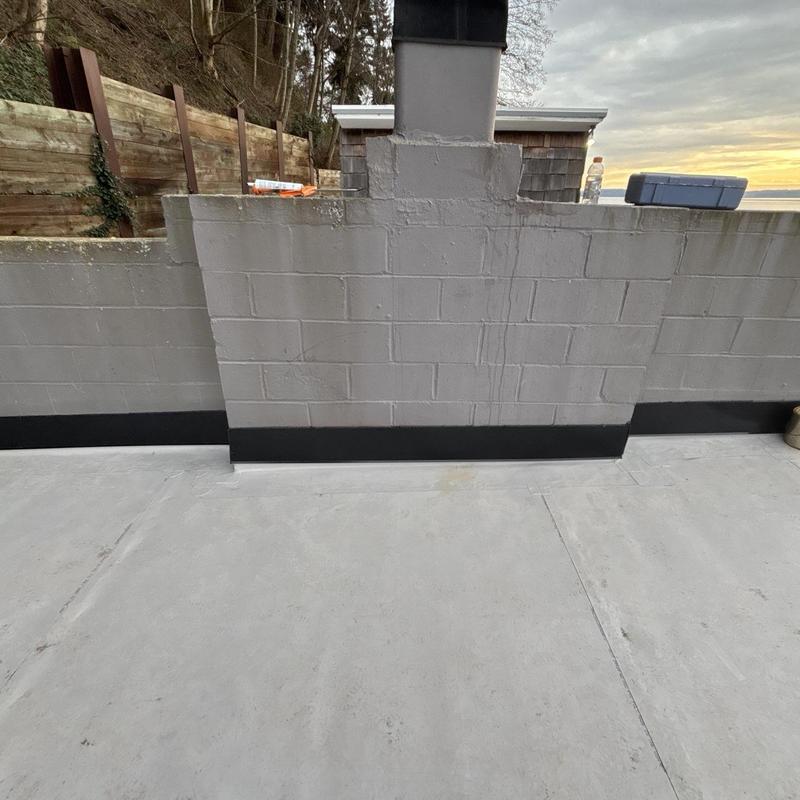 Roof edge flashing on flat concrete roof surface