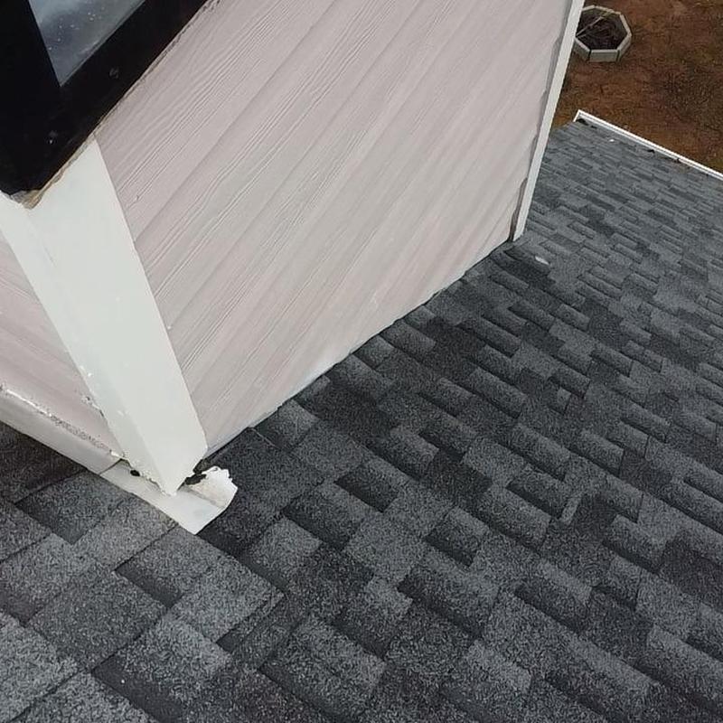 Roof shingles and flashing at wall base inspection