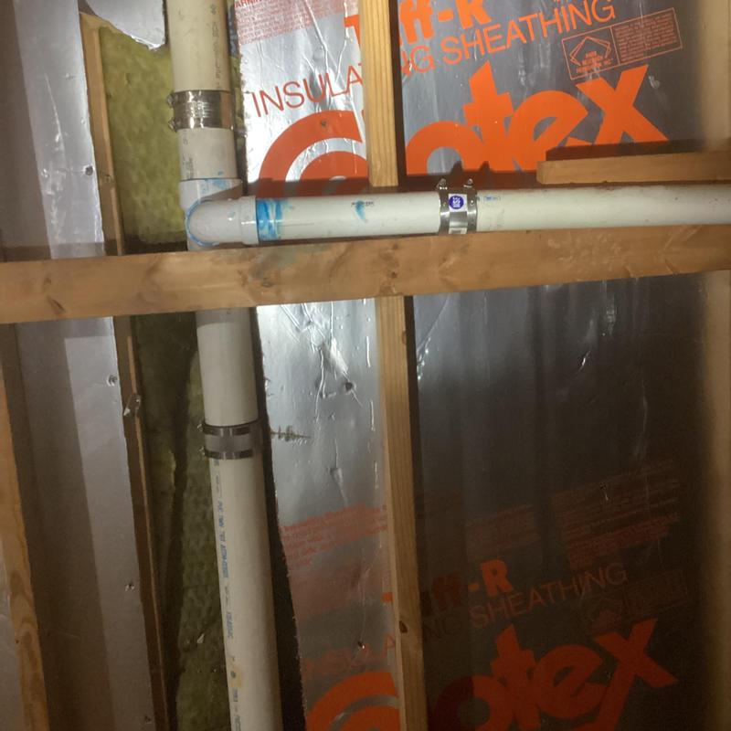 PVC water pipe with metal clamps in attic framing