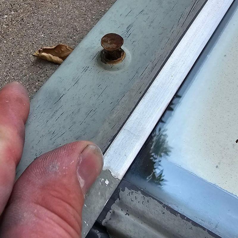 Skylight flashing with rusted nail on roof edge Skylight flashing with rusted nail on roof edge