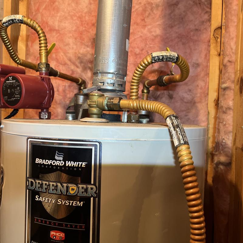 Water heater with gas line connections and vent pipe