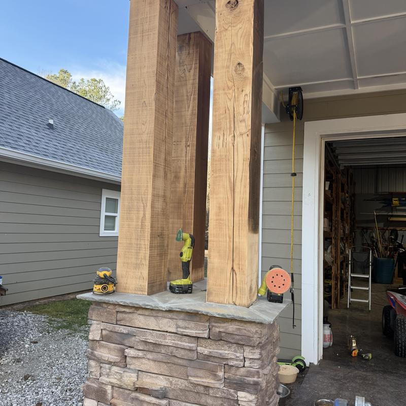 Wooden columns sanding with power tools outdoors Wooden columns sanding with power tools outdoors