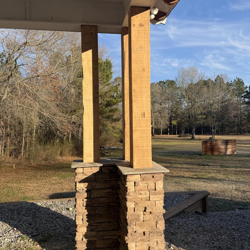 Wooden porch columns sanding before staining outdoors Wooden porch columns sanding before staining outdoors