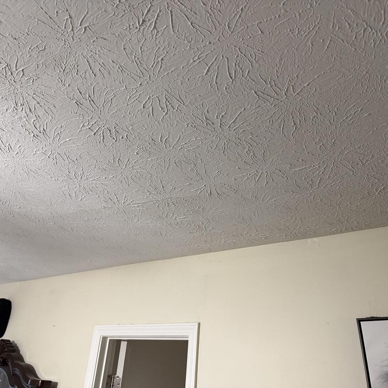 Ceiling crack close-up with textured drywall pattern