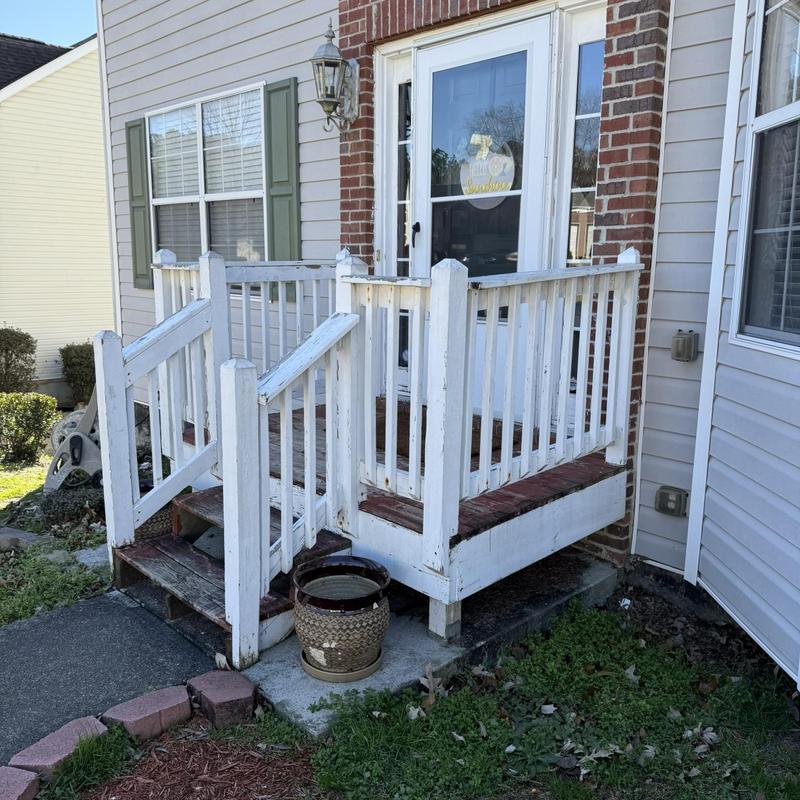 Front porch wood railing and steps with wear