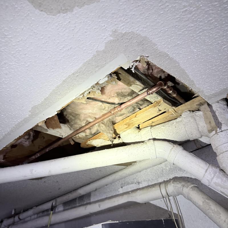 Copper water pipe with opened ceiling drywall cutout