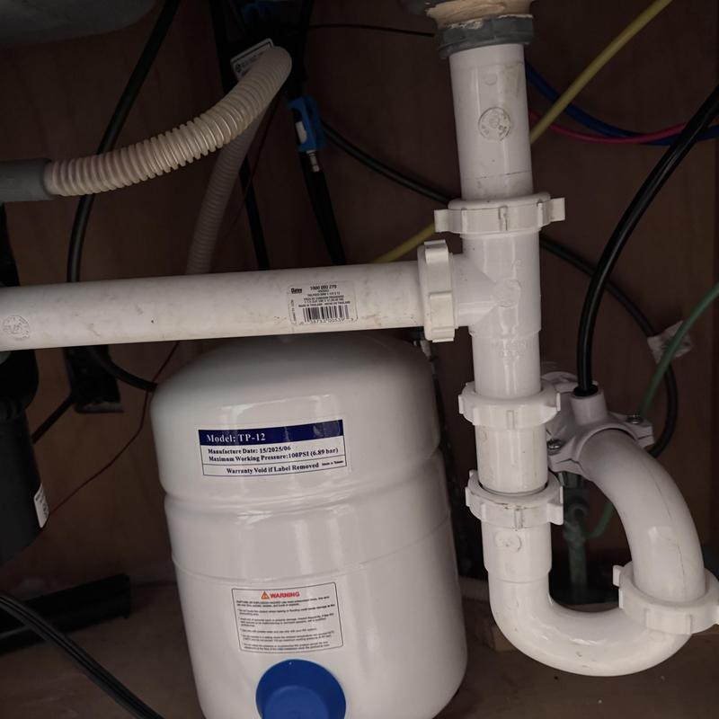 P trap and water pressure tank under kitchen sink