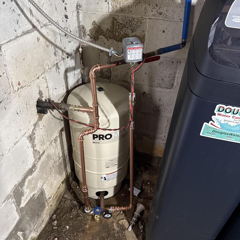 Bladder tank with pressure check valve installation