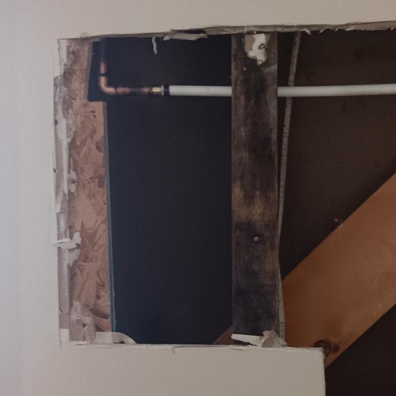 Frozen pipe with PVC replacement inside wall cavity