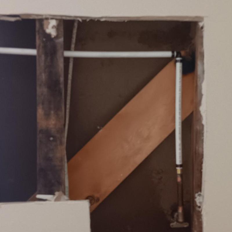 PVC pipe installation in interior wall cavity